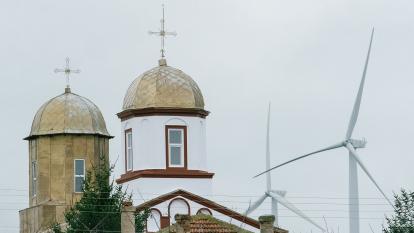 Wind turbines at the Fantanele-Cogealac wind farm, operated by CEZ group, beyond a church building in Constanta, Romania